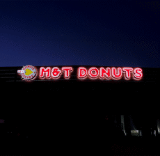 LED channel letter sign glowing on storefront at night by West Coast Sign Shop