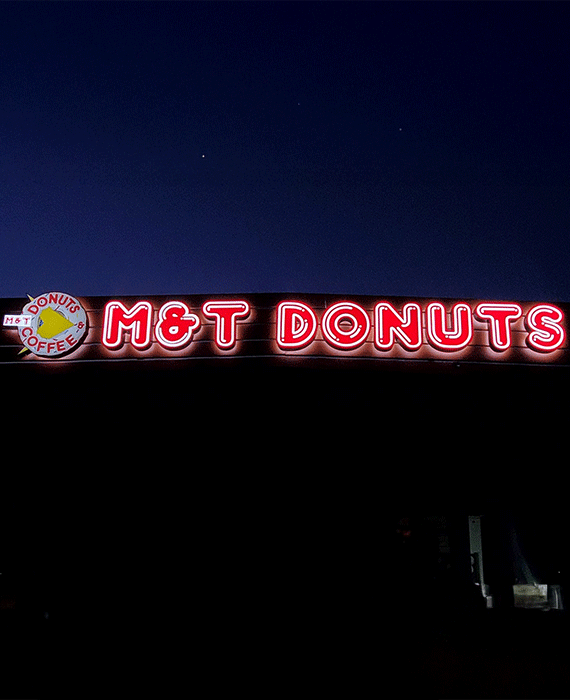 LED channel letter sign glowing on storefront at night by West Coast Sign Shop