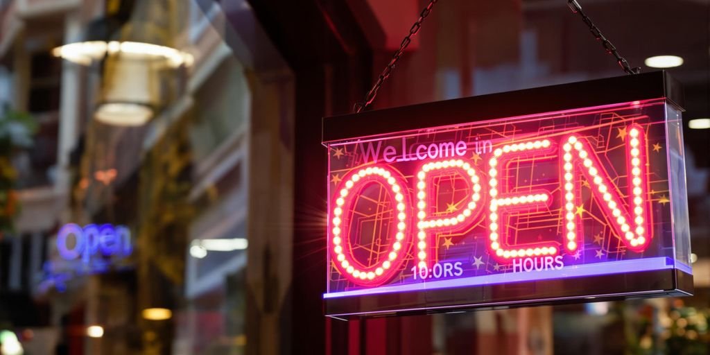 Bright open sign with business hours displayed.