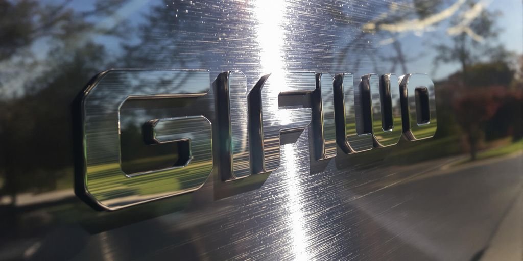 Elegant custom metal logo mounted outdoors.